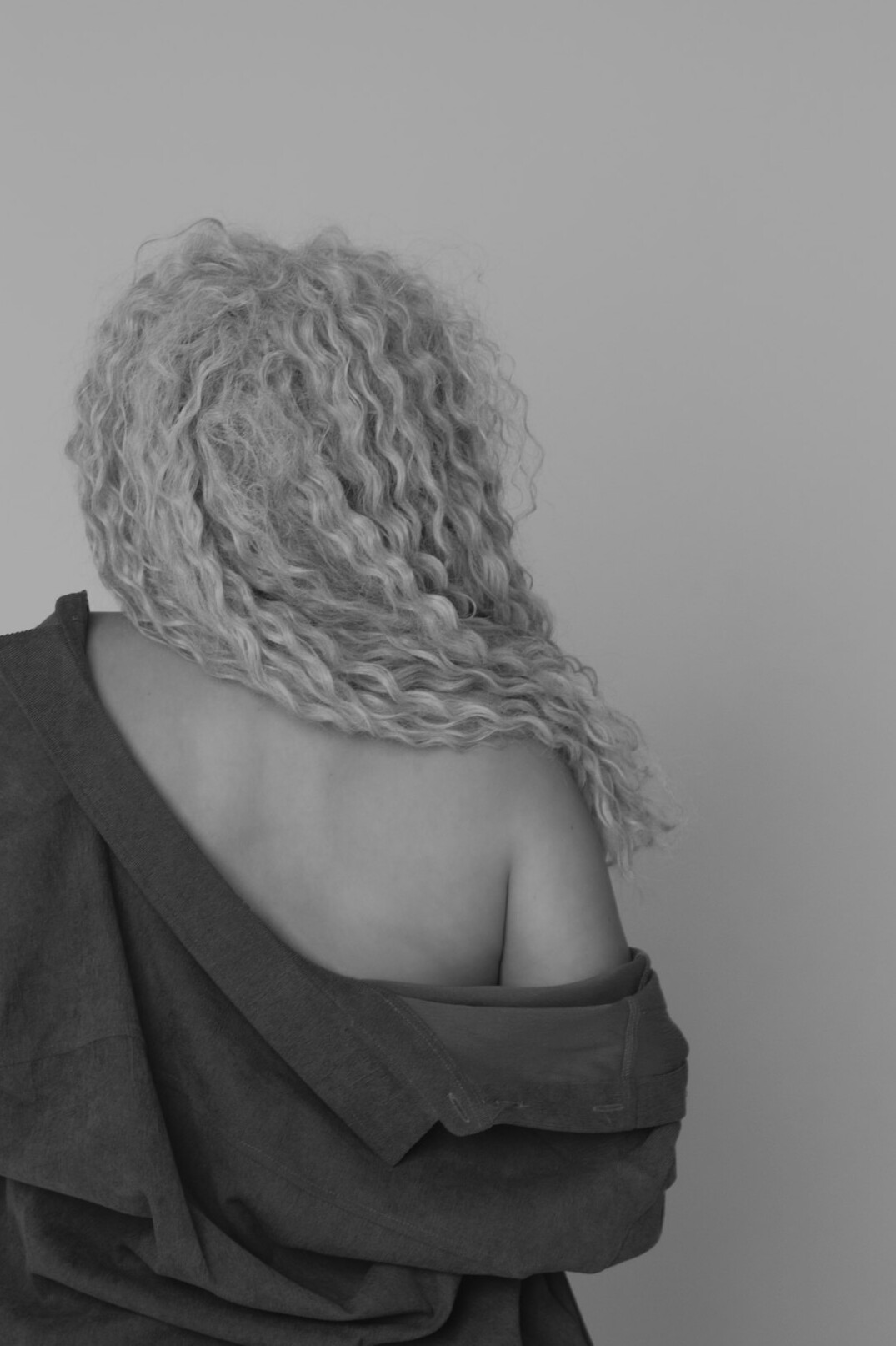 Studio portrait of a woman with curly hair