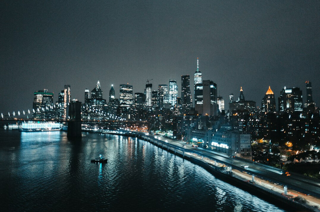 City skyline at dusk with lights turning on